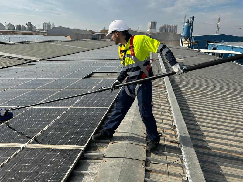 Operario trabajando en la limpieza de placas solares